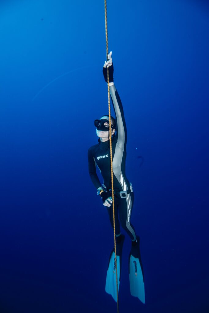 Freediver on the descent line during open water training