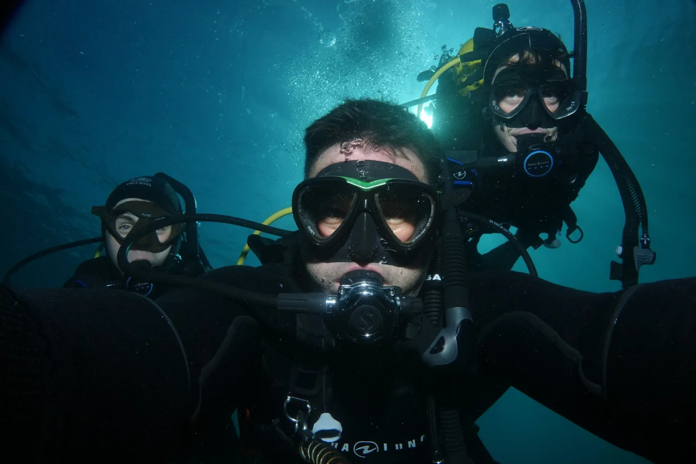 Three new divers with their instructor underwater in the Bay of Islands